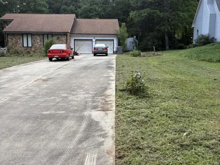 The same driveway after Gaskins Lawn Care mowed the lawn and edged the concrete