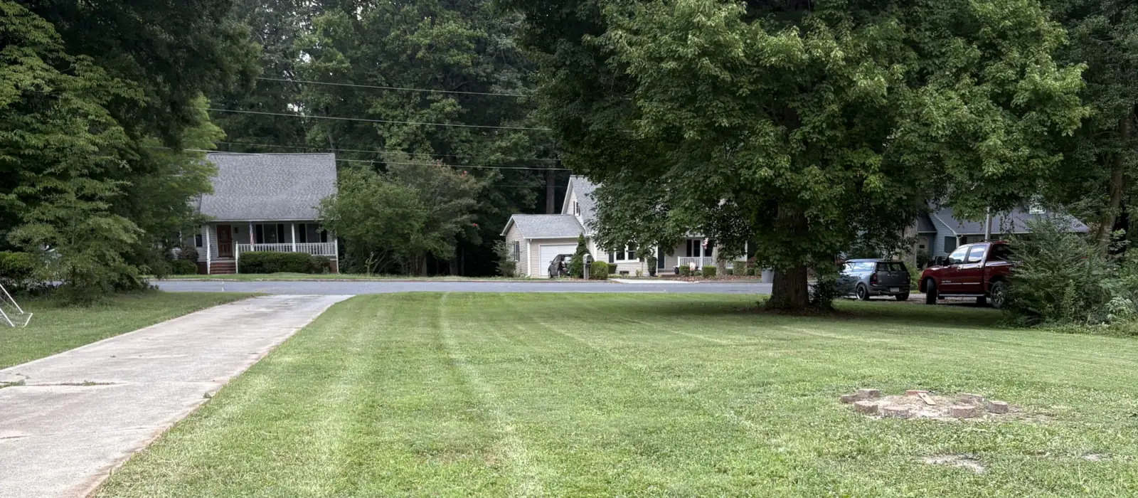 A front yard in Asheboro, NC with fresh mower stripes after a cut by Gaskins Lawn Care