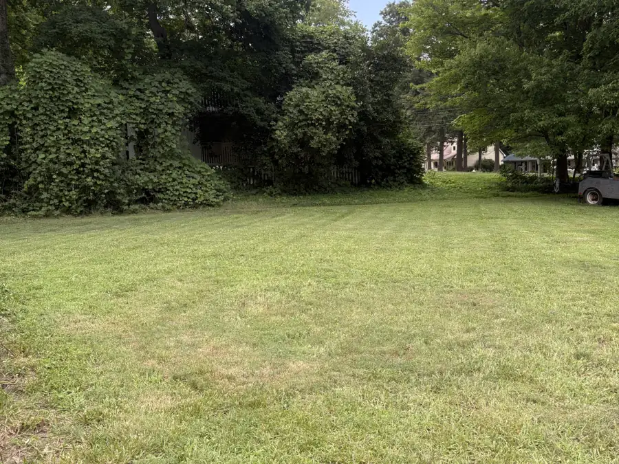A large back yard in Randolph County, NC after mowing, cut to an even height up to the treeline